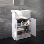 The iBathUK Bathroom Ceramic Suite includes a white vanity sink unit with soft close doors and a close coupled toilet, shown against gray textured tiles and a dark floor, with towels, soap, and toiletries neatly displayed in the open cabinet.