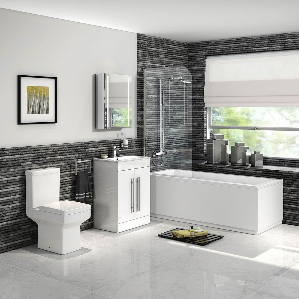 The iBathUK Arvon Shower Bath Suite features a straight bathtub with glass screen, gloss vanity basin unit with mirror, close coupled toilet set, combined toilet and sink unit—all in a modern design with gray stone walls and white tiles.
