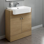 The iBathUK Harper 2 Door Floorstanding Vanity Unit with Semi Recessed Basin (660mm x 800mm) features a light wood finish, silver handles, and sits against gray tiled walls and floors for a modern bathroom look.