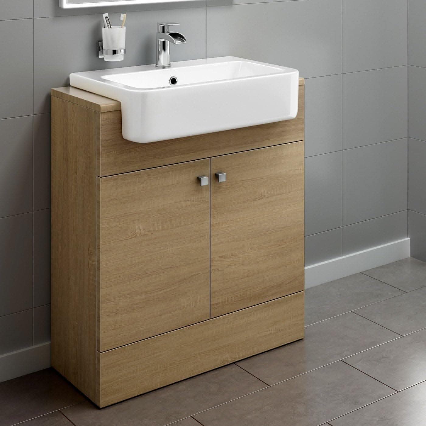 The iBathUK Harper 2 Door Floorstanding Vanity Unit with Semi Recessed Basin (660mm x 800mm) features a light wood finish, silver handles, and sits against gray tiled walls and floors for a modern bathroom look.
