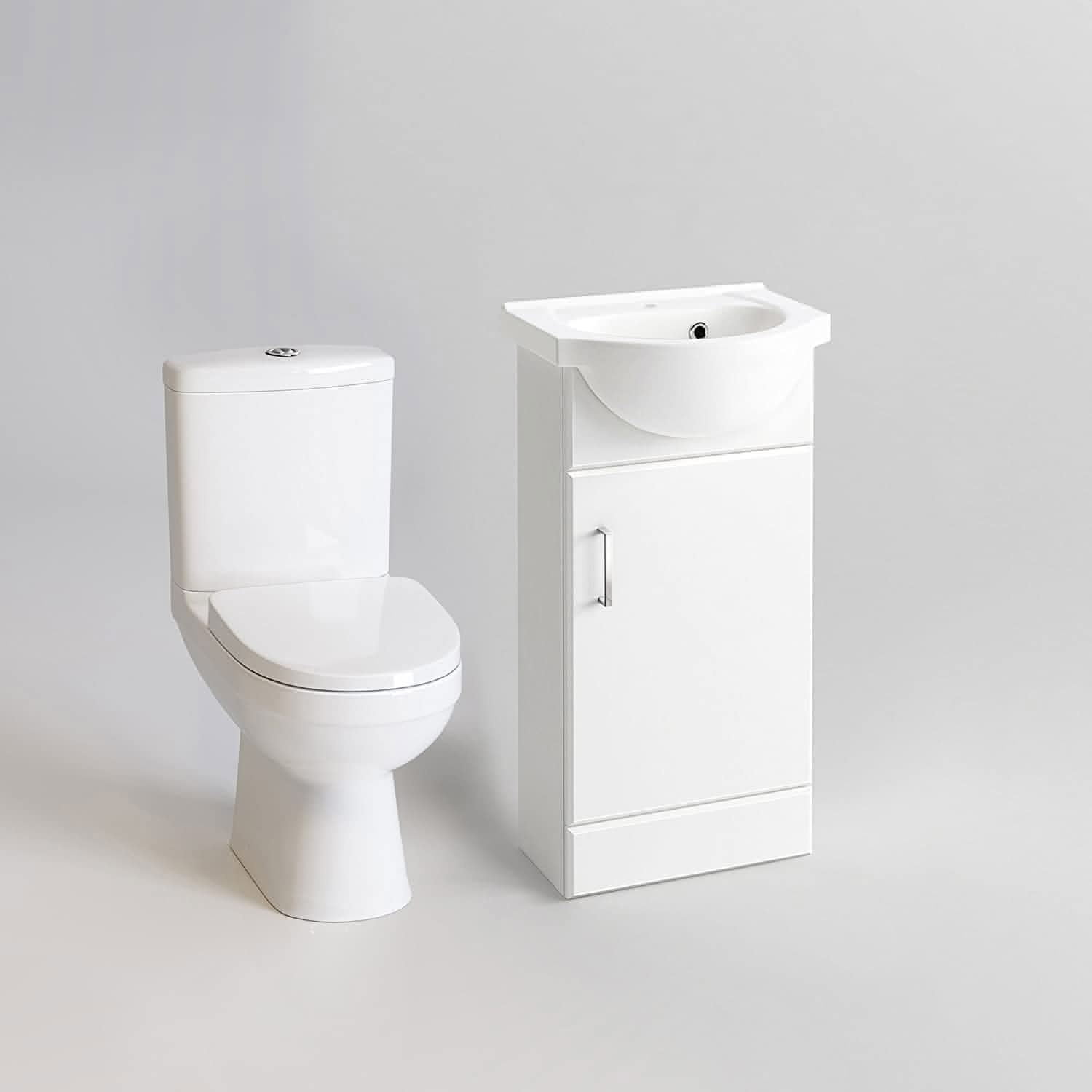 The iBathUK Petite Modern Bathroom Suite in gloss white features a sleek toilet and compact vanity with integrated sink and cabinet, all set against a light gray backdrop for a fresh, contemporary look.