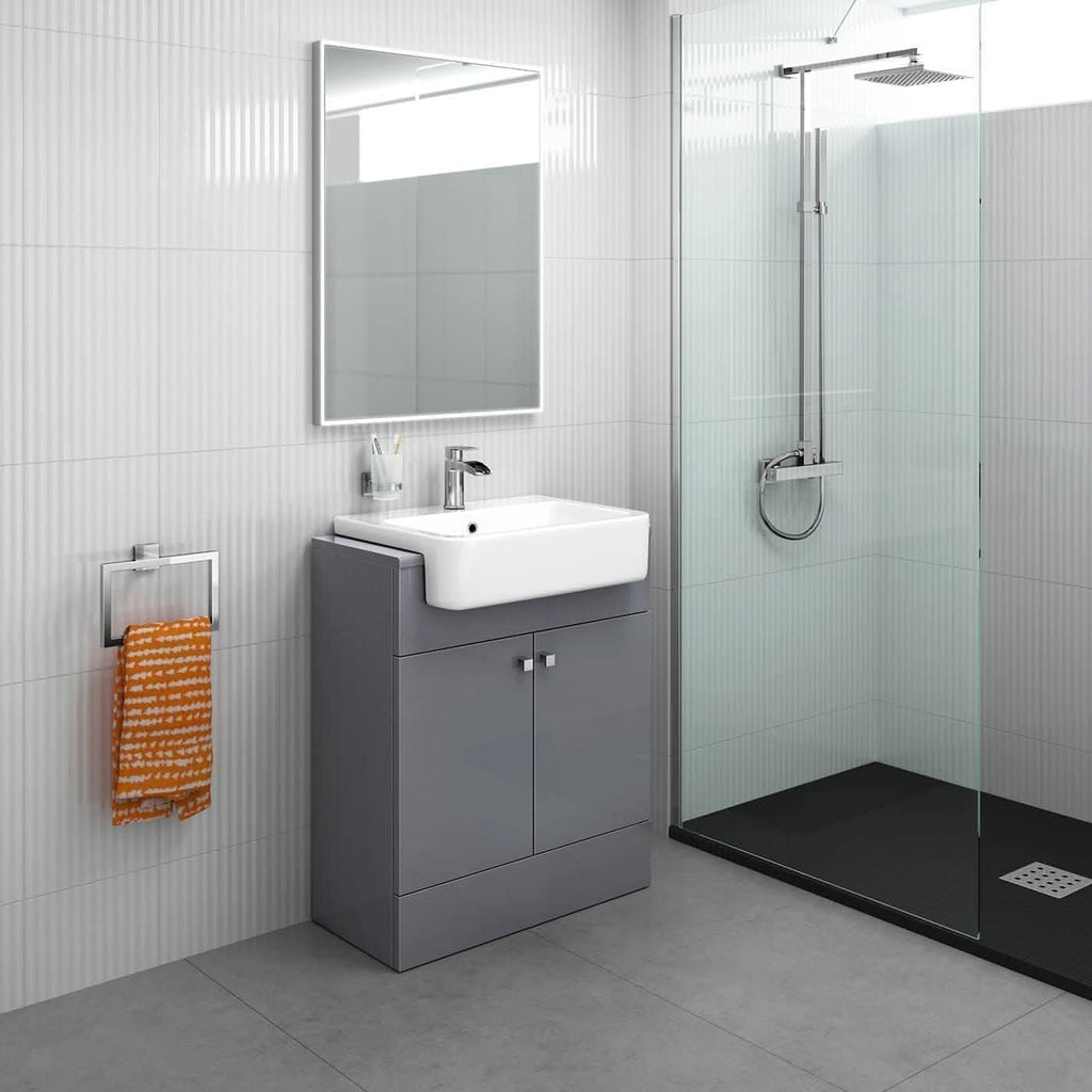 Modern bathroom featuring the iBathUK Harper 2 Door Floorstanding Vanity Unit With Semi Recessed Basin (660mm x 800mm), white sink, mirror above, wall-mounted faucet, rainfall shower in glass enclosure, orange towel on metal rack, and light gray walls and floor.