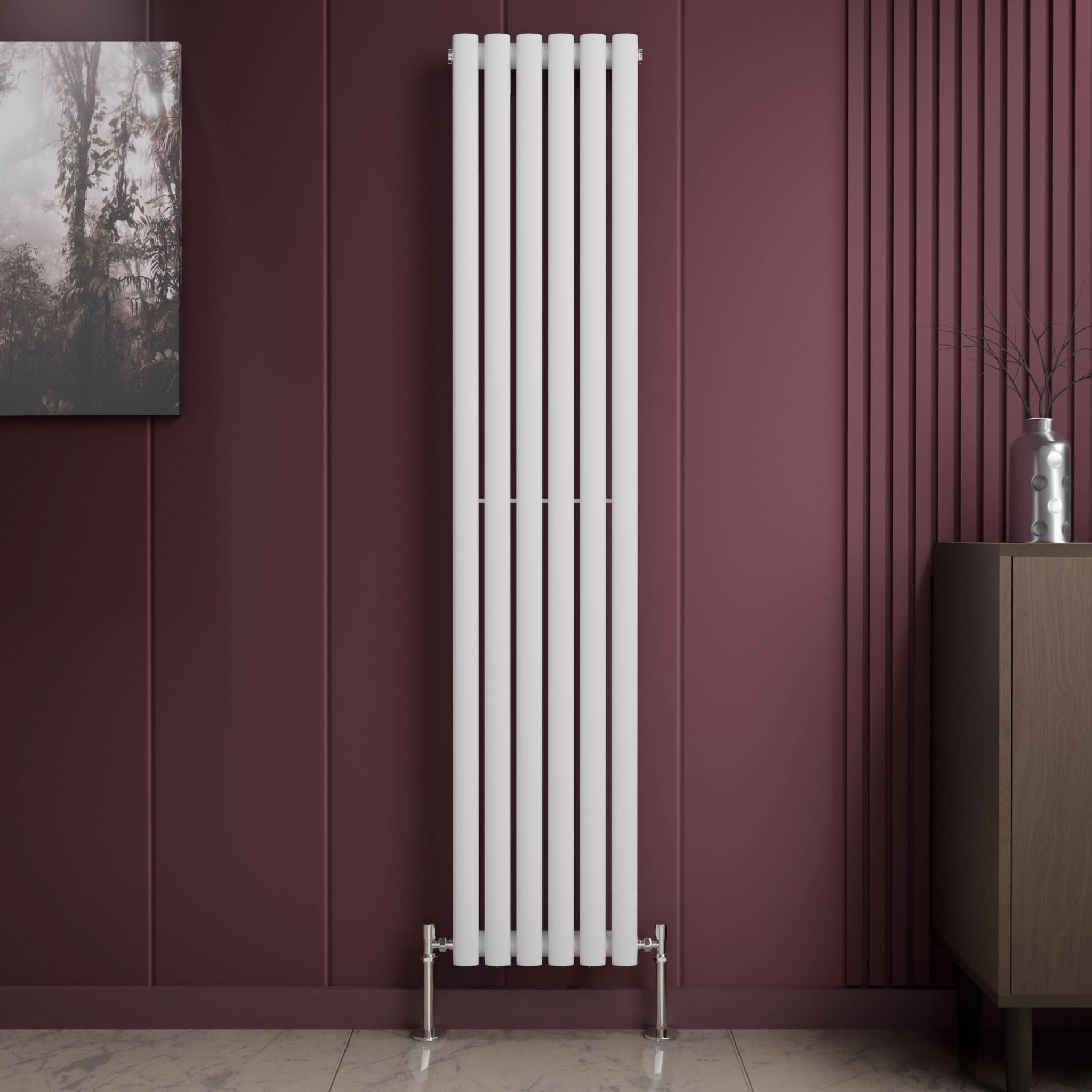The iBathUK Princia Vertical Single Oval Panel Radiator in white stands against a burgundy panelled wall beside a brown cabinet and wall art. The light-toned floor features a subtle marble pattern.