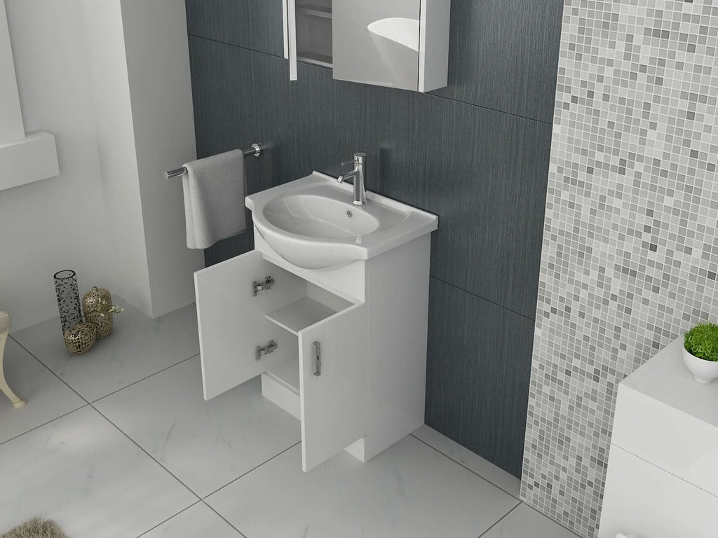 A modern bathroom features the iBathUK Quartz MDF Gloss White Vanity Unit with Basin; open cabinet doors reveal storage space. The wall is finished in dark gray and mosaic tiles, with a towel hanging on a nearby rail.